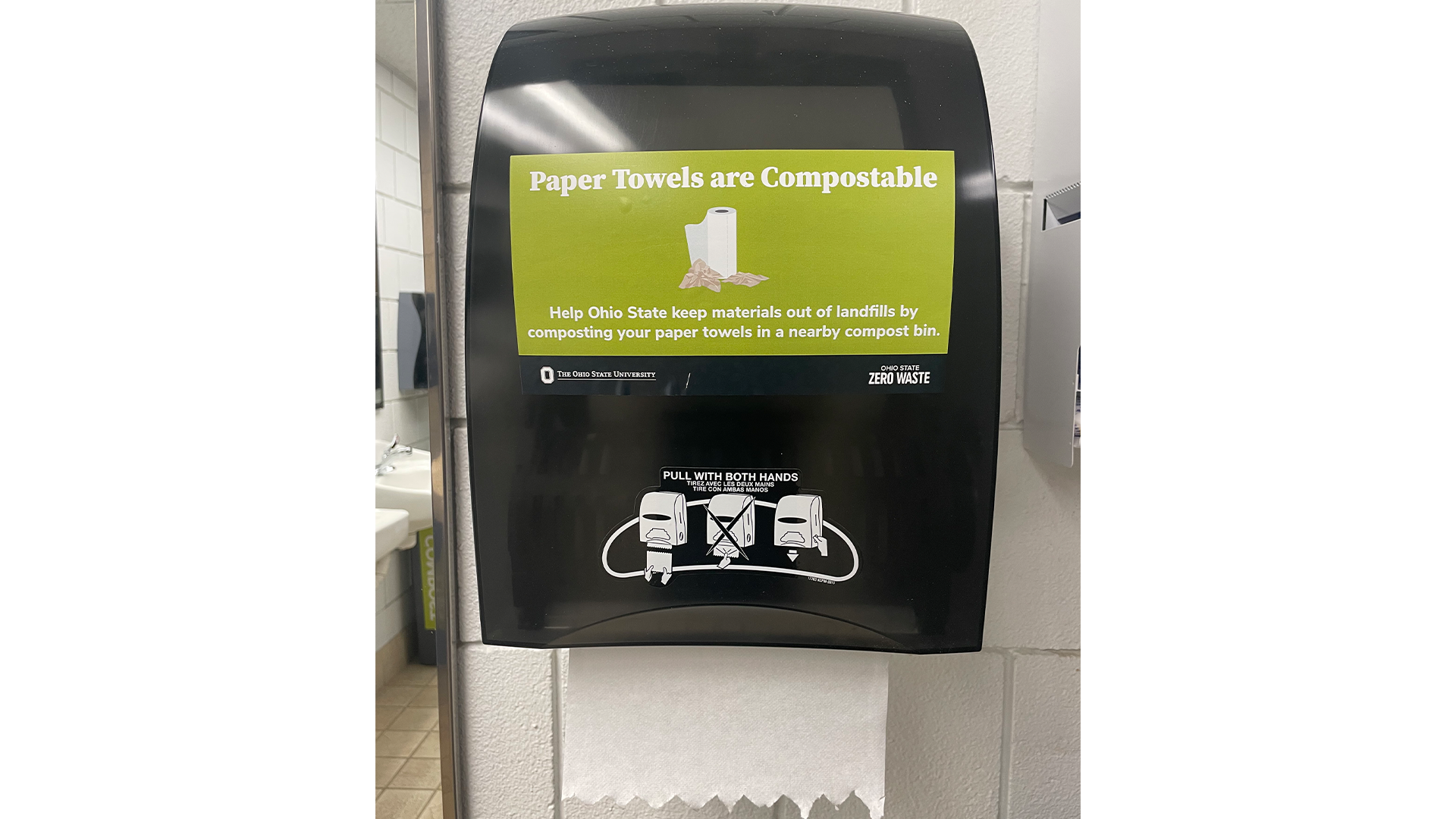 Compostable paper towels with a sign on the bin that says, "paper towels are compostable"