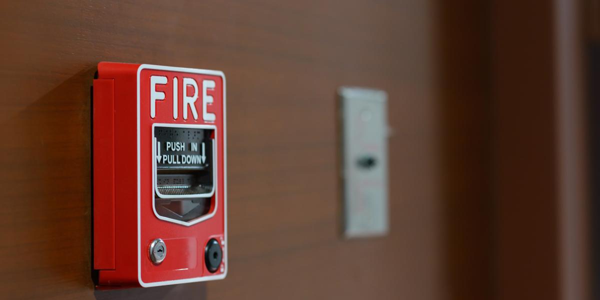 Fire alarm on brown wall