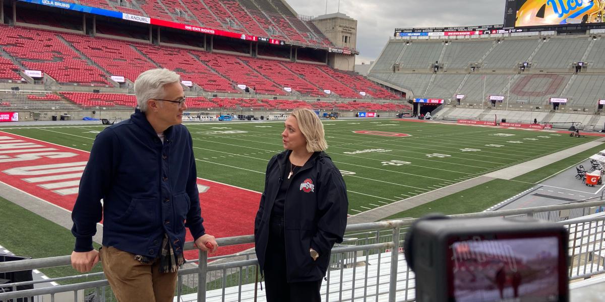 Mary Leciejewski talking with a CBS News reporter at Ohio Stadium.