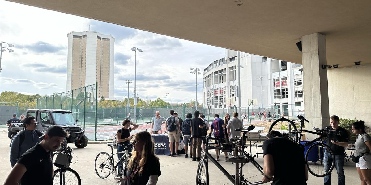 A view of the Buckeye Bike Hub with about 12 people with their bikes enjoying the event.