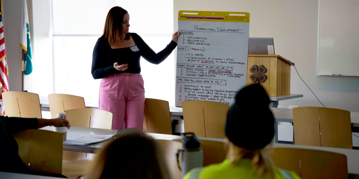 Casey Paris holding a large paper with written notes on it.