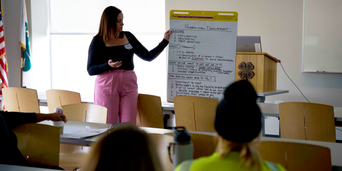 Casey Paris holding a large paper with written notes on it. 