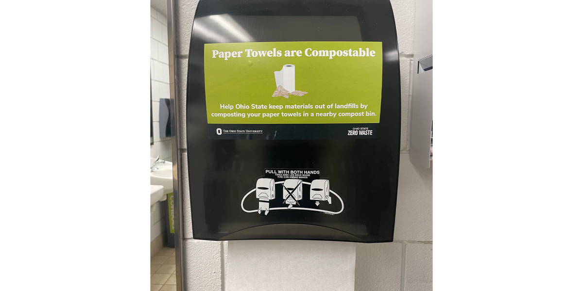 Compostable paper towels with a sign on the bin that says, "paper towels are compostable"