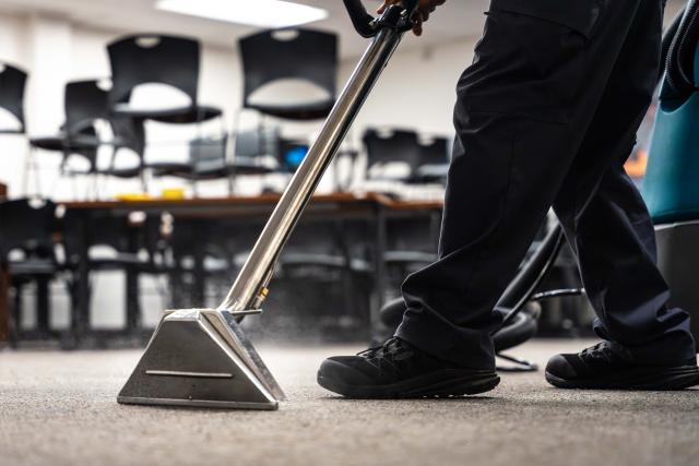 A close-up photo of a vacuum on the carpet.