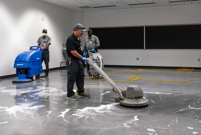 Facilities Operations and Development staff performing maintenance on a classroom floor