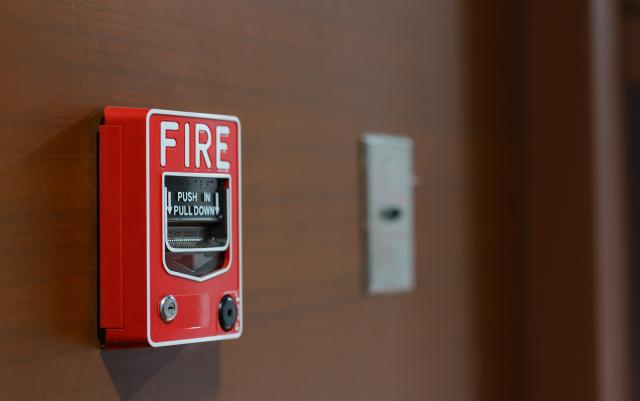 Fire alarm on brown wall