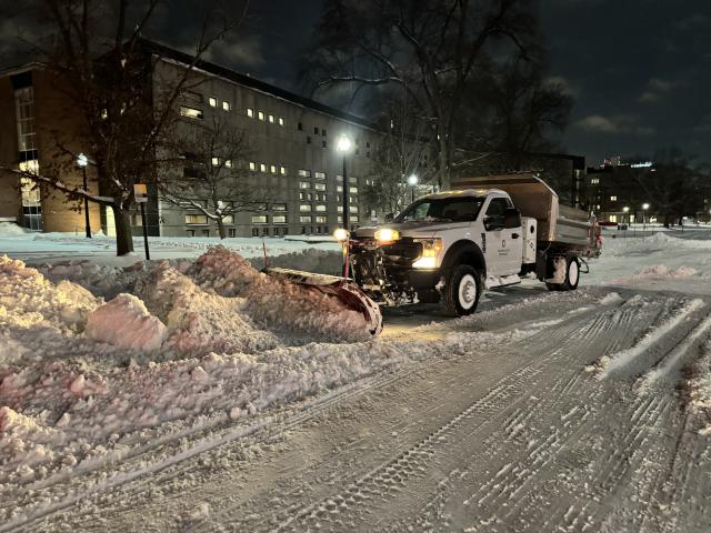 Snow plow clearing snow on campus