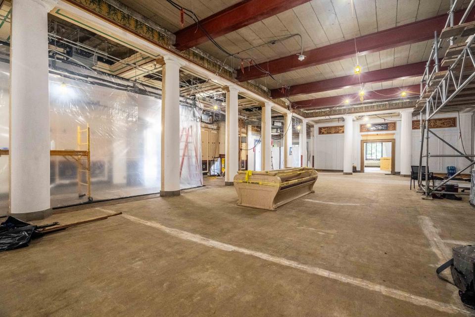 A view of the central common area where large white pillars can be seen along with unfinished floor.