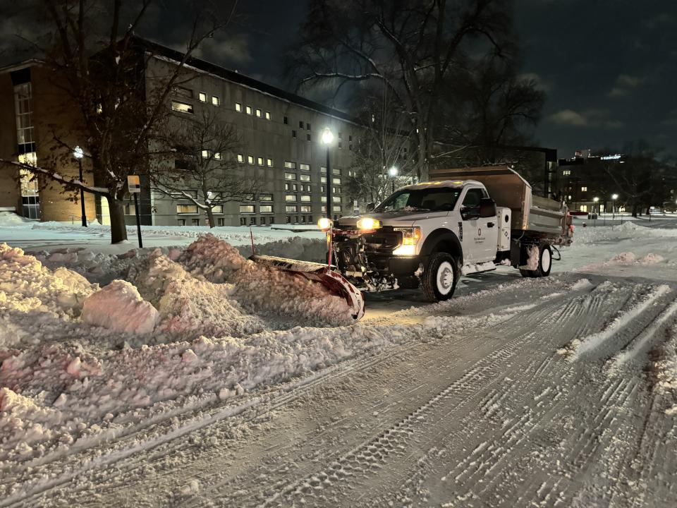 Snow plow clearing snow on campus