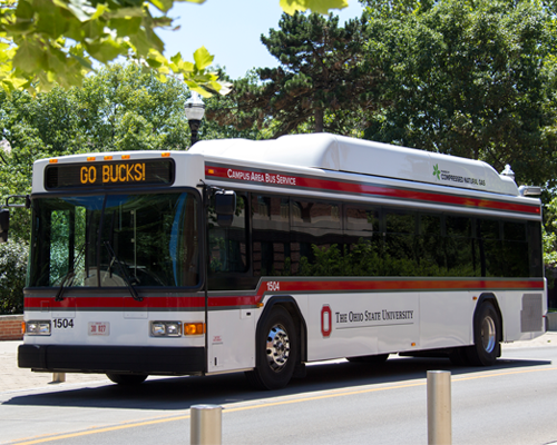 An Ohio State bus driving on the road.