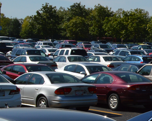Cars parked in a full parking lot